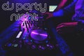 Inscription Dj Party Night on the background hands of a DJ mixing music on a mixer Royalty Free Stock Photo