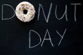 inscription donut day on a chalk board and sweet glaze donut