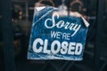 Inscription on a door: Sorry we are closed. Conceptual photo or table on door with information of work. Announcement or