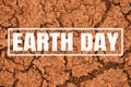 Inscription Earth Day on red cracked ground background. Royalty Free Stock Photo