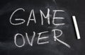 Inscription in English game over with white chalk on a black board Royalty Free Stock Photo