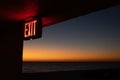 Inscription Exit on the building on the seashore during sunset Royalty Free Stock Photo