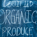 Inscription on a farmers` market for certified organic produce written on a blackboard with chalk.