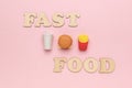 The inscription fast food and a takeaway set on a pink background Royalty Free Stock Photo