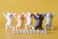 Inscription felinology next to funny toy dancing kittens from the meme. Yellow background. The science of cats, their health and