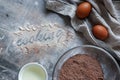 The inscription flour `Cooking` on a gray wooden messy background. Flour mixture, eggs and sunflower oil. Cozy culinary cover, con