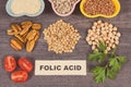 Inscription folic acid, healthy nutritious products or ingredients as source natural vitamin B9, dietary fiber and other minerals Royalty Free Stock Photo