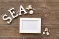 Inscription, frame and seashells the table