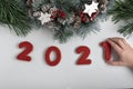 Inscription 2021 from gingerbread cookie, child hand taking cookie. New Year and Christmas decor Royalty Free Stock Photo