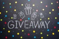 The inscription Giveaway is written on the blackboard, Free distribution, bloggers and gifts, instagram, social network