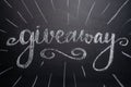 The inscription giveaway is written on a blackboard with gifts. Distribution of gifts. Blog, bloggers, social networks, instagram