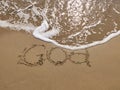 Inscription Goa on the sandy beach and foamy sea water Royalty Free Stock Photo