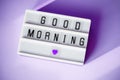 The inscription good morning on a light box with gingerbread on a lilac background Royalty Free Stock Photo