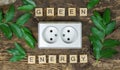 The inscription Green Energy on wooden cubes and an electrical outlet. The concept of environmental conservation Royalty Free Stock Photo