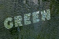 Inscription: Green on mirror glass under water drops