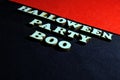 Inscription HALLOWEEN PARTY made of wooden letters on a black background. Red upper right corner of the frame. Royalty Free Stock Photo