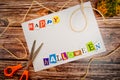 Inscription `Happy Halloween` with empty copy space on wooden table with pumpkin, scissors and lashing.