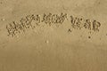 Inscription Happy new year on the sand Royalty Free Stock Photo