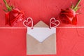 Inscription Happy Valentine Day on red background, copy space on empty card with craft envelope, roses and hearts Royalty Free Stock Photo