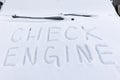 inscription on the hood of a frozen broken car covered with snow, parked outside on a frosty winter day. the engine does not star