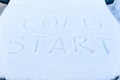 inscription on the hood of a frozen broken car covered with snow, parked outside on a frosty winter day. the engine does not star