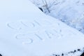 inscription on the hood of a frozen broken car covered with snow, parked outside on a frosty winter day. the engine does not star