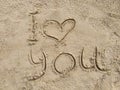 The inscription `I love you` on wet sand Royalty Free Stock Photo