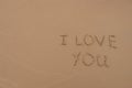 The inscription `I love you` painted on the sand. Royalty Free Stock Photo