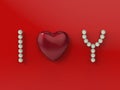 Inscription I love You with red heart and pearls isolated on red background