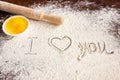 The inscription I love you on sprinkled flour, rolling pin and eggs. Baking recipes. Valentine`s day concept. Declaration of love Royalty Free Stock Photo