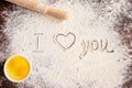 The inscription I love you on sprinkled flour, rolling pin and eggs. Baking recipes. Valentine`s day concept. Declaration of love Royalty Free Stock Photo