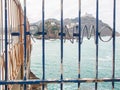 Inscription `Jeronimo` on metallic fence and Atlantic Ocean behind in San Sebastian