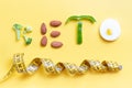 Inscription keto composed of vegetables and measuring tape on yellow background