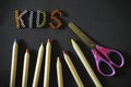 Inscription kids, colorful crayons and children`s scissors