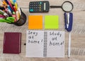 The inscription `learn from home` on a notebook. School supplies on a wooden table. View from above. Royalty Free Stock Photo