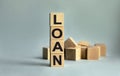 The inscription LOAN on wooden cubes isolated on a light background. The image symbolizes the beginning of the new year