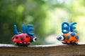 The inscription love in German. Next to it are two figures of ladybirds made of plasticine Royalty Free Stock Photo