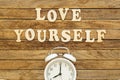 The inscription Love yourself made of wooden letters on a wooden background. Royalty Free Stock Photo