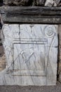 An inscription on a mable stone at the ancient site of Perge in Turkey Royalty Free Stock Photo
