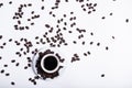 Inscription made of coffee beans on white background next to a cup of coffee Royalty Free Stock Photo