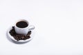 Inscription made of coffee beans on white background next to a cup of coffee Royalty Free Stock Photo