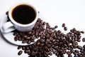 Inscription made of coffee beans on white background next to a cup of coffee Royalty Free Stock Photo