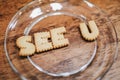 Inscription made of cookies `SEE YOU` Plate with alphabet Biscuits on wooden table Royalty Free Stock Photo