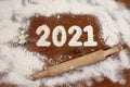 The inscription 2021 is made of flour on a wooden table