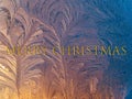 The inscription merry christmas on a background of frost