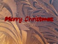 The inscription merry christmas on a background of frost