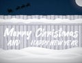 The inscription Merry christmas Happy new year on the winter fence with snowdrift Royalty Free Stock Photo