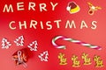 The Inscription Merry Christmas made of wooden letters, lying flat from above, isolated on a red background. Visible candy canes, Royalty Free Stock Photo