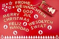 The Inscription Merry Christmas made of wooden letters, lying flat from above, isolated on a red background. Visible candy canes, Royalty Free Stock Photo