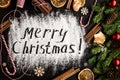 Inscription MERRY CHRISTMAS on powdered sugar. Top view Royalty Free Stock Photo